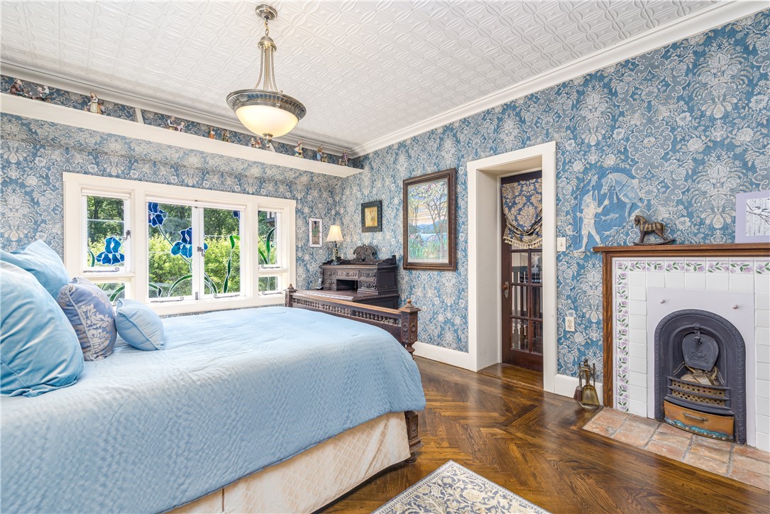 2550 Vineyard Road North Kingstown, RI 02874 - Photo 26 of 50 Stained glass windows, english fireplace, herringbone hardwood floors and tin ceilings make this the perfect bedroom