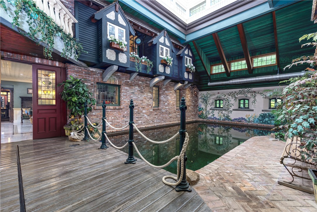 2550 Vineyard Road North Kingstown, RI 02874 - Photo 29 of 50 Indoor pool has brick patio and trex decking. There are stained glass reclaimed doors to pool table/game room and balconies are overlooking the pool