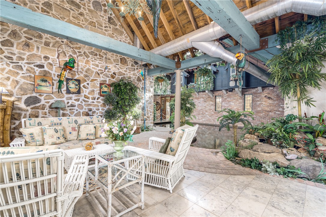 2550 Vineyard Road North Kingstown, RI 02874 - Photo 31 of 50 Overlooking the indoor pool this room is perfect for entertaining, it has a marble fireplace from Italy and limestone radiant heated floors and patio doors out to brick patio