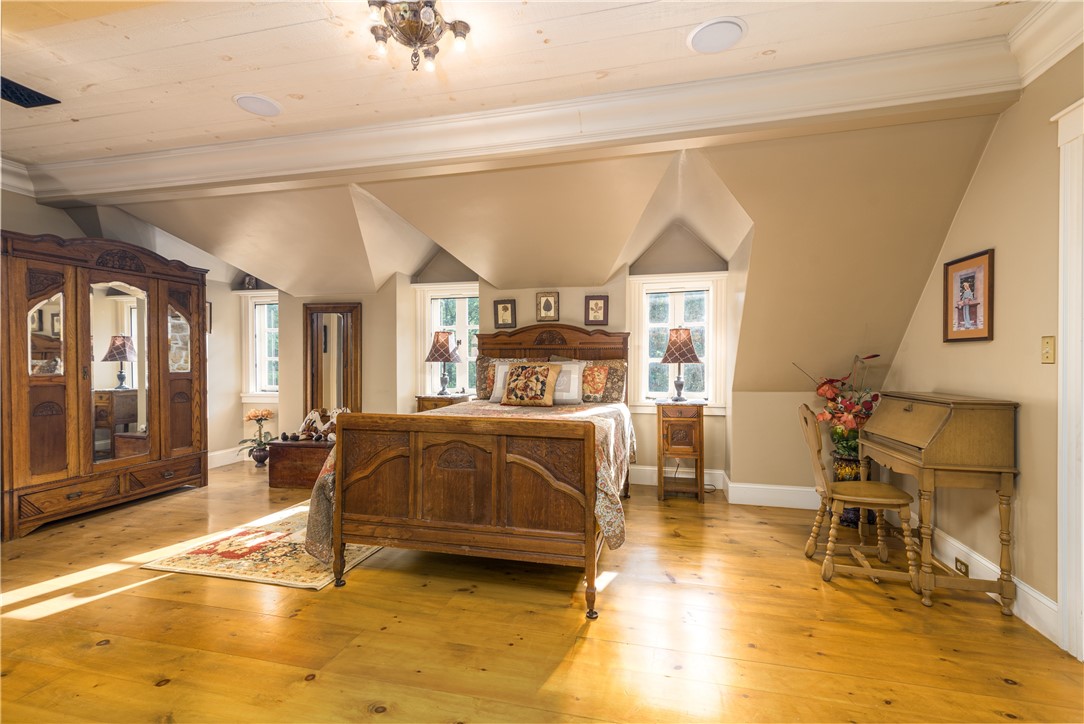 2550 Vineyard Road North Kingstown, RI 02874 - Photo 35 of 50 Third floor bedroom with pine wide plank floors and a stone fireplace with balcony
