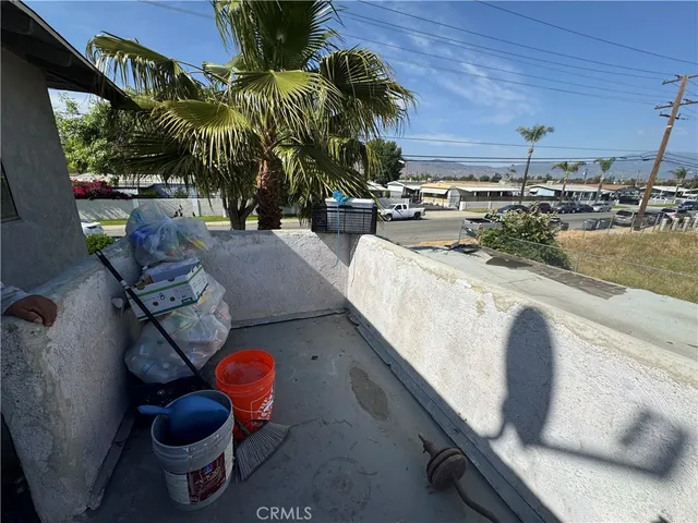 a bed sitting in a bedroom next to a lamp