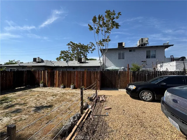 a bedroom with bed and a large mirror