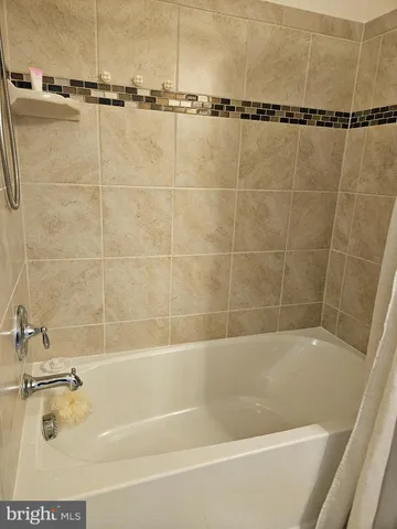 a bathroom with a shower and a bath tub