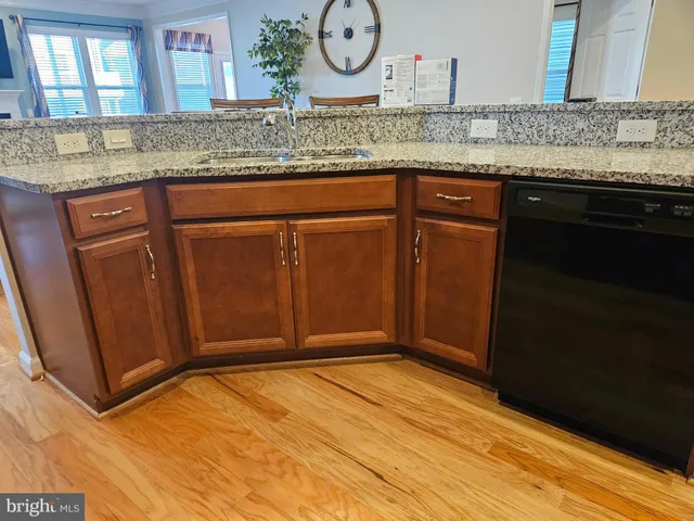 a view of a kitchen counter space and wooden floor