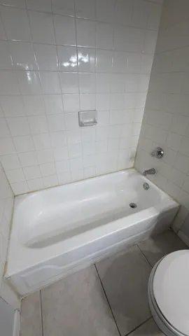 a bathroom with a bathtub and shower