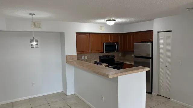a kitchen with a microwave a sink and cabinets