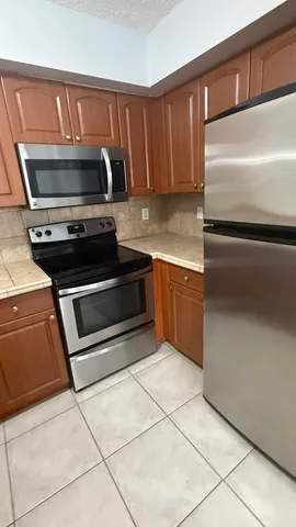 a stove top oven sitting inside of a kitchen