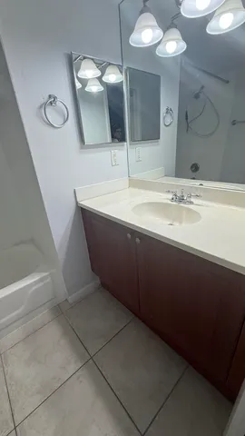 a bathroom with a double vanity sink and a mirror