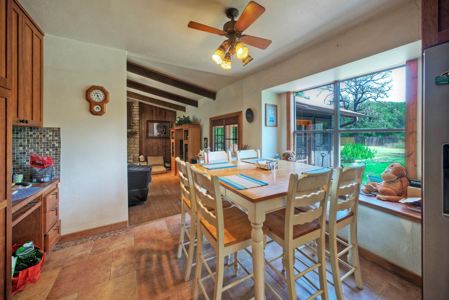 2300 Robin Road Manchaca, TX 78652 - Photo 15 of 36 An inviting dining area benefits from a large window framing serene garden views.