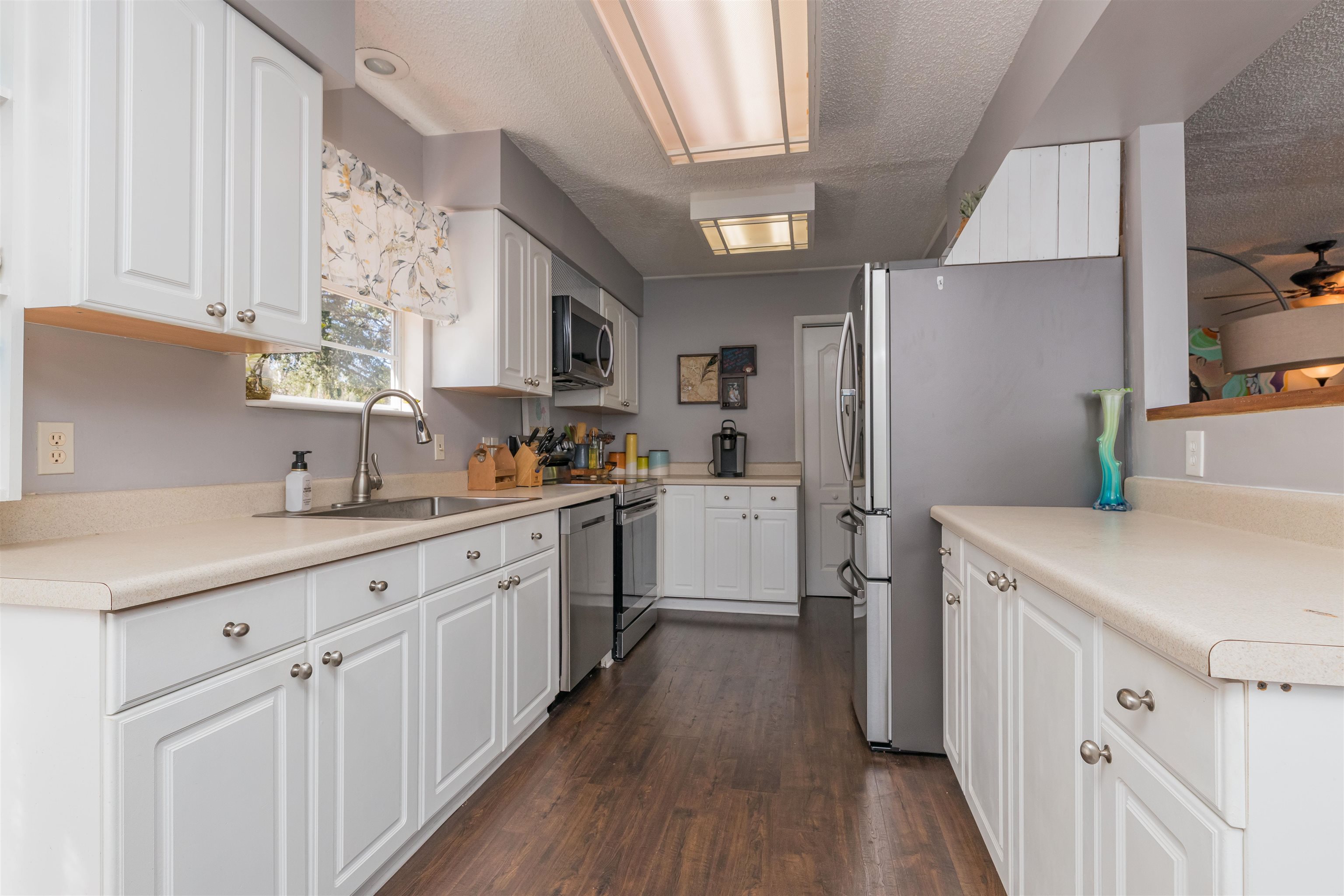 802 Royal Road St. Augustine, FL 32086 - Photo 12 of 47 a kitchen with white cabinets sink and white appliances