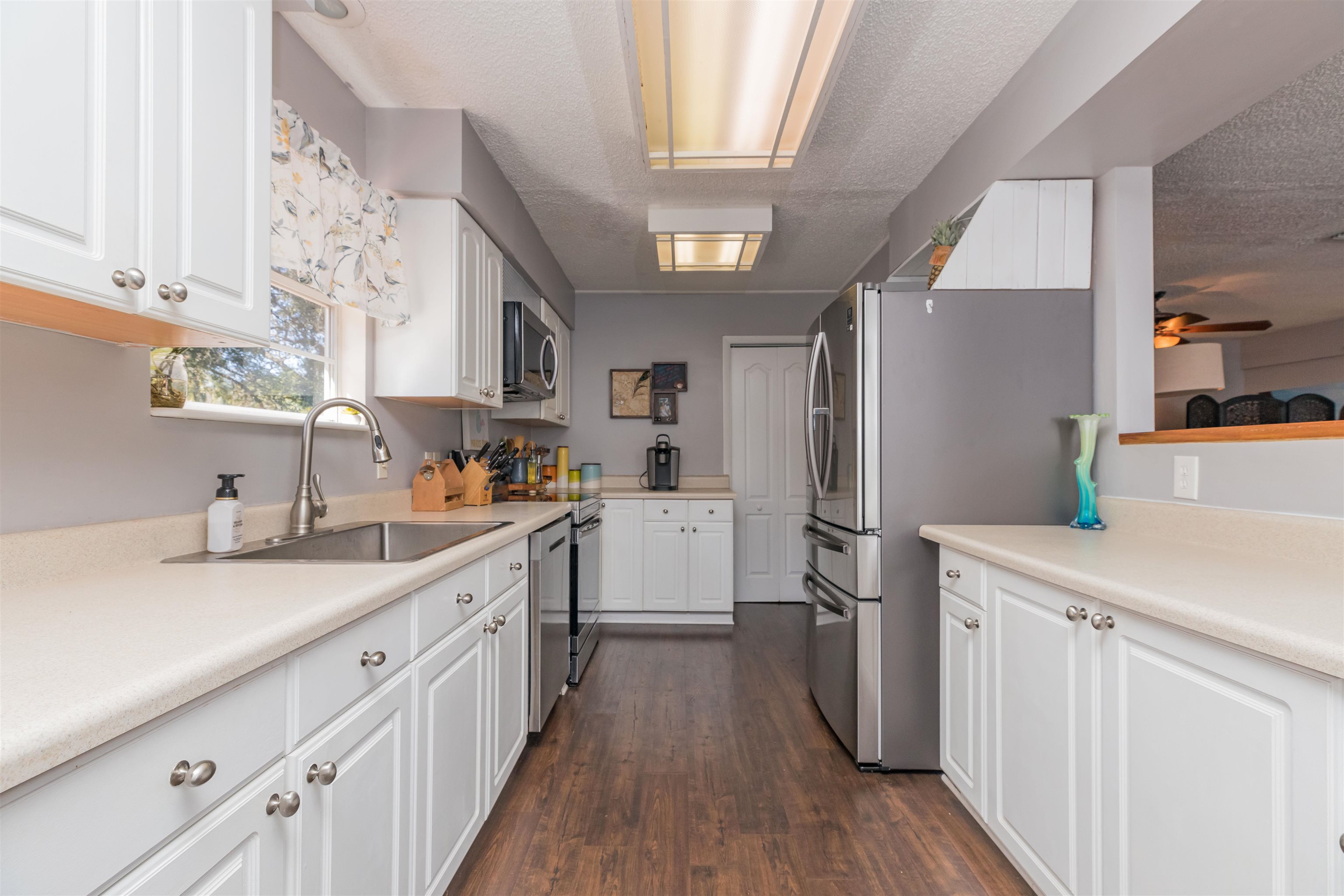 802 Royal Road St. Augustine, FL 32086 - Photo 13 of 47 a kitchen with a sink a counter top space stainless steel appliances and cabinets