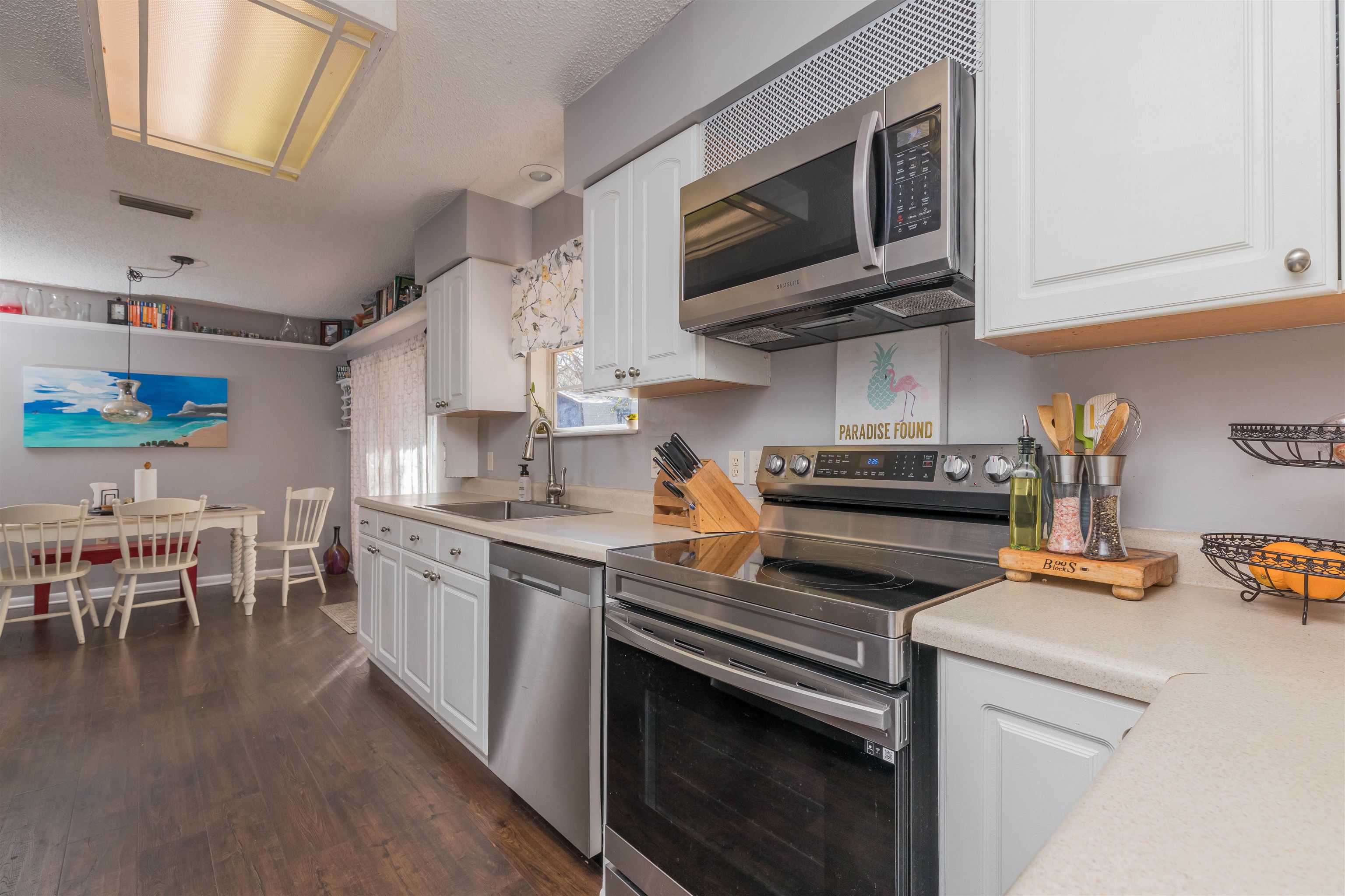 802 Royal Road St. Augustine, FL 32086 - Photo 14 of 47 a kitchen with stainless steel appliances granite countertop a stove top oven a sink dishwasher and white cabinets