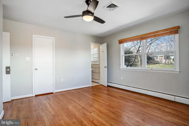 a bathroom with a granite countertop sink a toilet a mirror and vanity