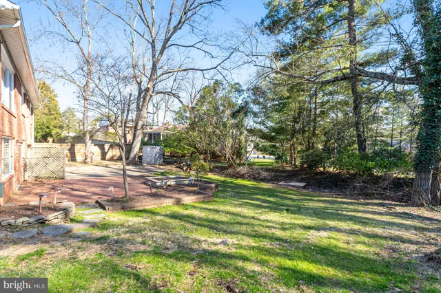 a front view of a house with a yard covered in snow