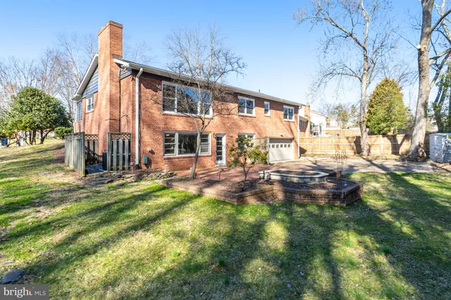 a front view of a house with a yard covered in snow