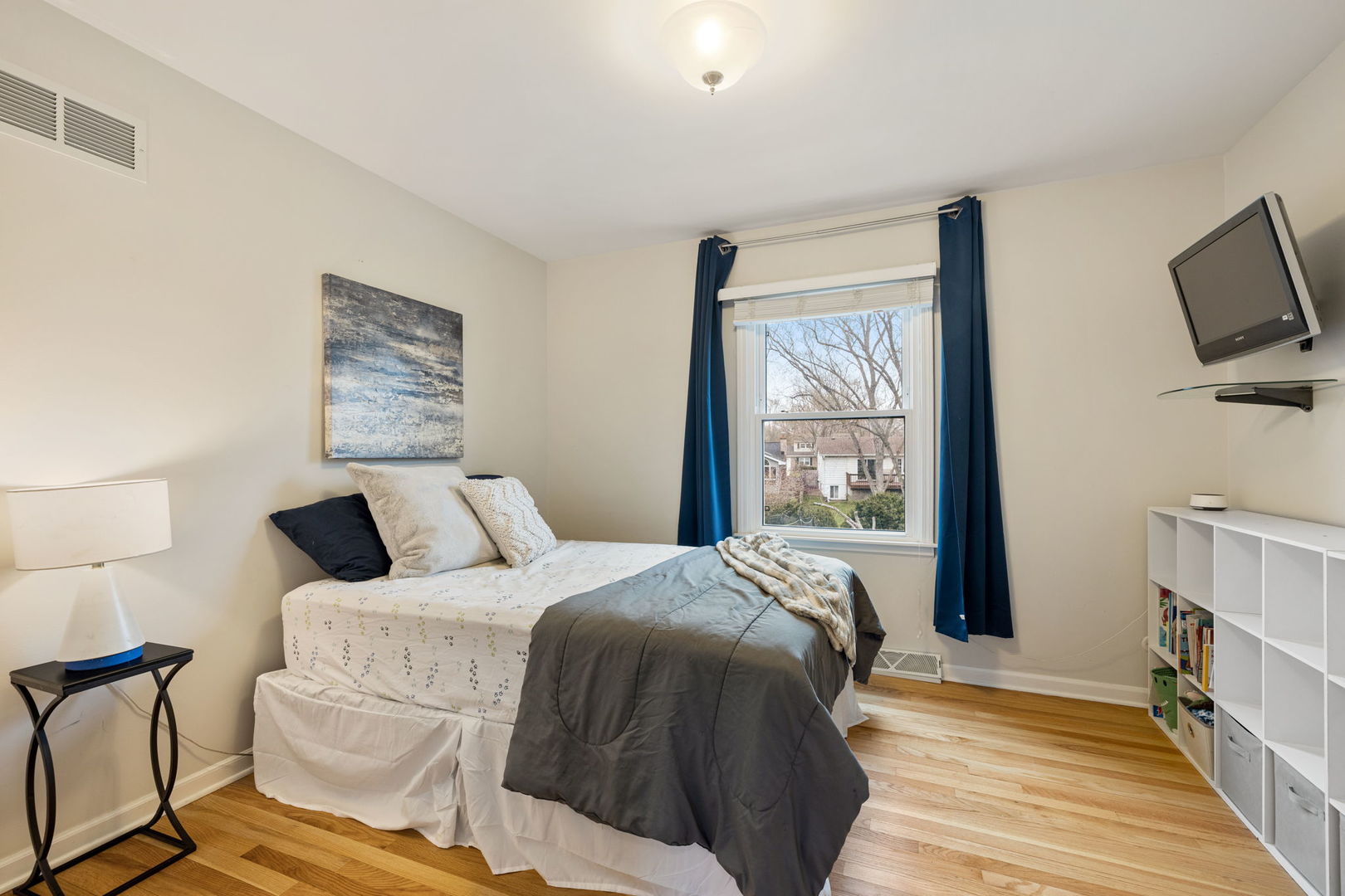 1635 Orth Drive Wheaton, IL 60189 - Photo 10 of 36 a bedroom with a bed flat screen tv and a window