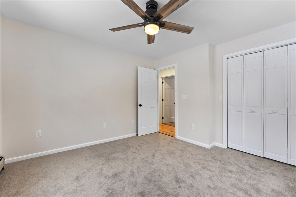 282 Loudville Road, Unit 1 Easthampton, MA 01027 - Photo 22 of 40 a view of an empty room with a ceiling fan