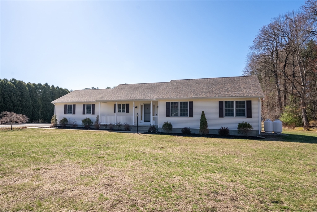 282 Loudville Road, Unit 1 Easthampton, MA 01027 - Photo 35 of 40 a front view of a house with a garden and trees