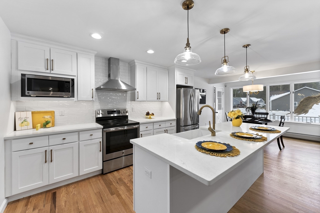 282 Loudville Road, Unit 1 Easthampton, MA 01027 - Photo 4 of 40 a kitchen with sink and stove