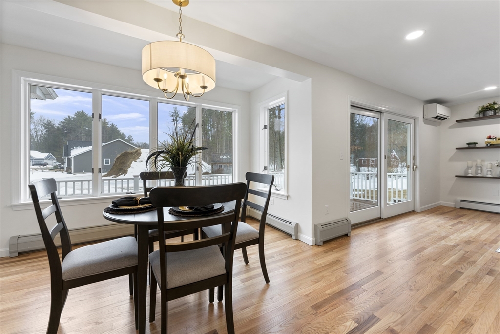 282 Loudville Road, Unit 1 Easthampton, MA 01027 - Photo 10 of 40 a view of a dining room with furniture wooden floor and a chandelier