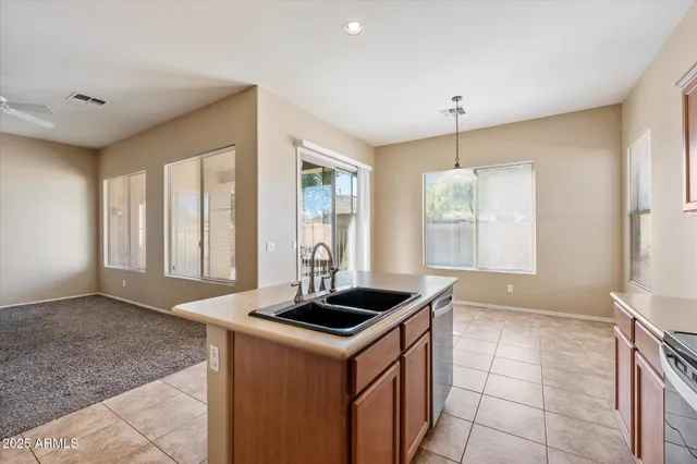 a kitchen with granite countertop a sink and a stove