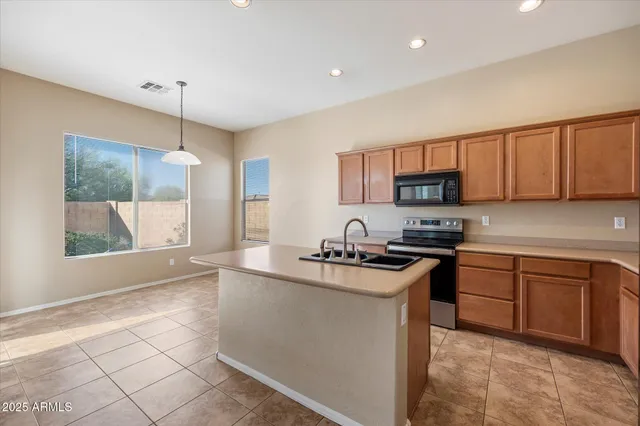 a kitchen with stainless steel appliances granite countertop a sink stove and refrigerator