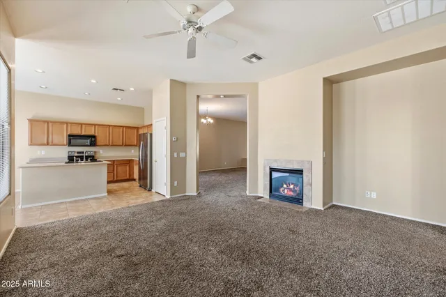 a view of kitchen with refrigerator and window