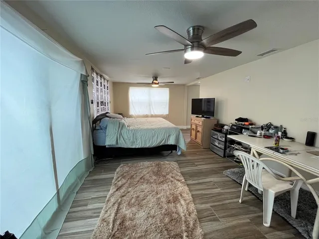 a view of a swimming pool with a patio and a yard