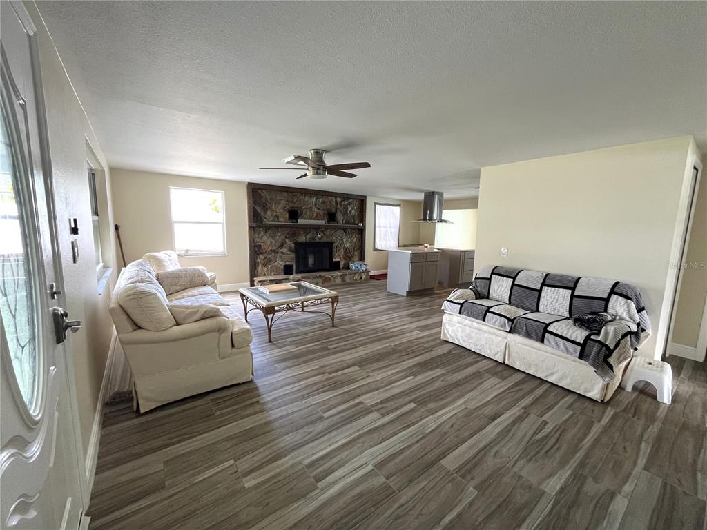 13630 Lagoon Drive Hudson, FL 34667 - Photo 4 of 26 a living room with furniture and a flat screen tv