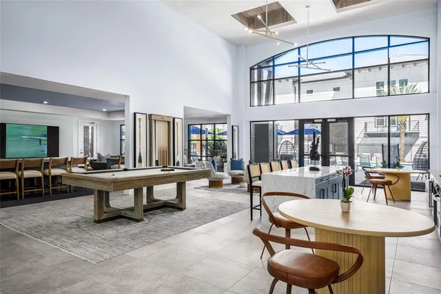 a living room with furniture a table and a large window