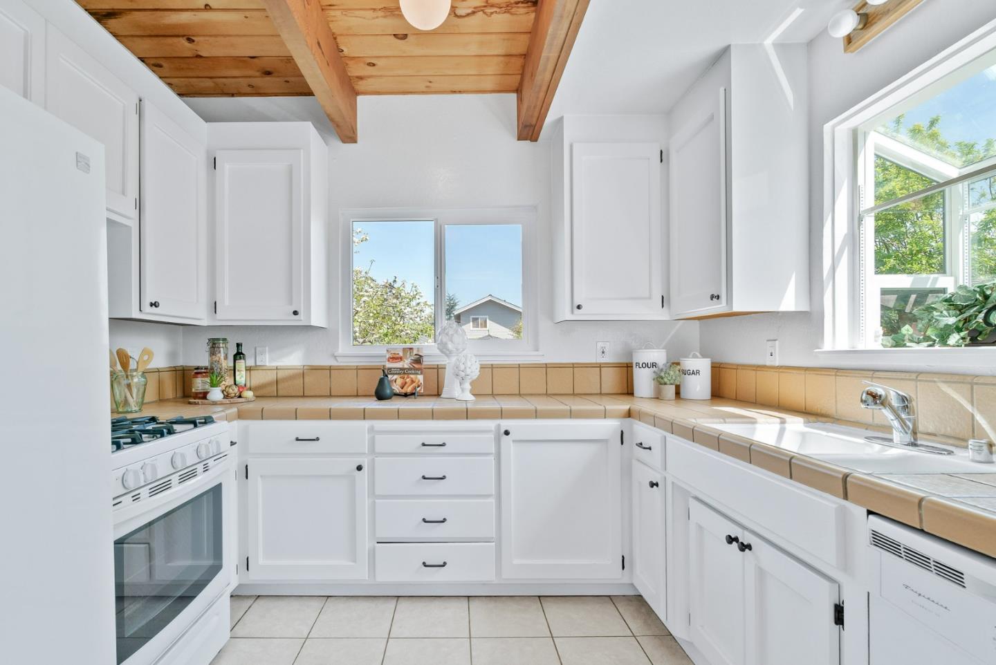 620 Sumner Street Santa Cruz, CA 95062 - Photo 11 of 45 a kitchen with white cabinets sink and window