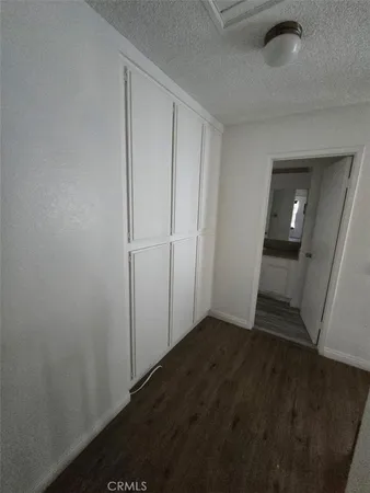 a view of a hallway view with wooden floor