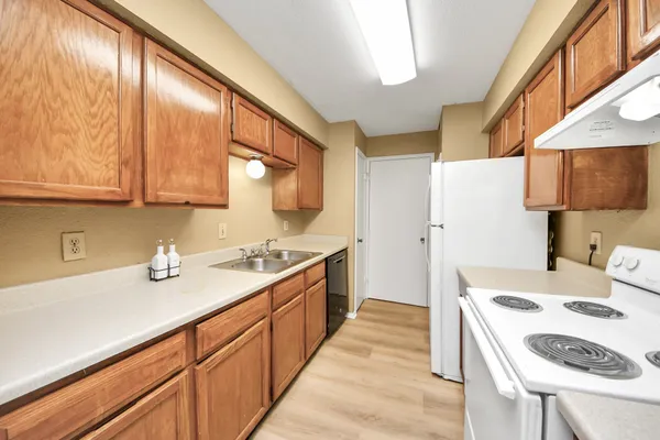 a kitchen with a sink a stove and a refrigerator