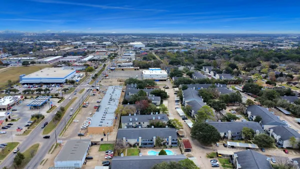 an aerial view of residential houses with outdoor space
