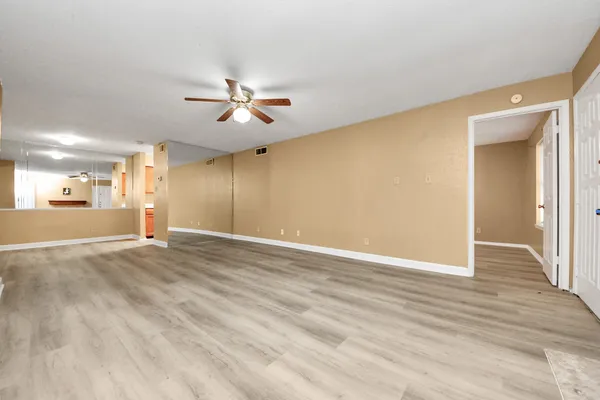 wooden floor in an empty room with a window