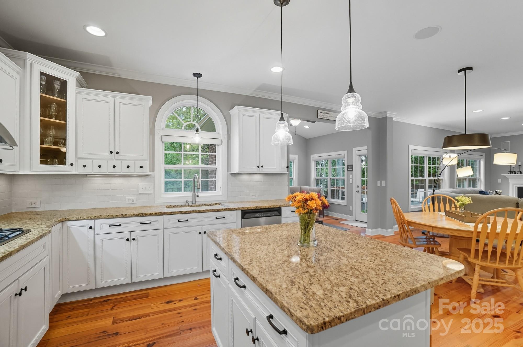 1651 Scotch Pine Lane Tega Cay, SC 29708 - Photo 16 of 48 a kitchen with stainless steel appliances granite countertop a sink a stove and a large window