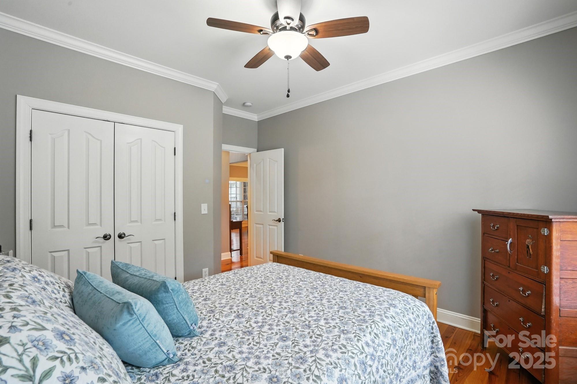1651 Scotch Pine Lane Tega Cay, SC 29708 - Photo 23 of 48 a bedroom with a bed and a chandelier