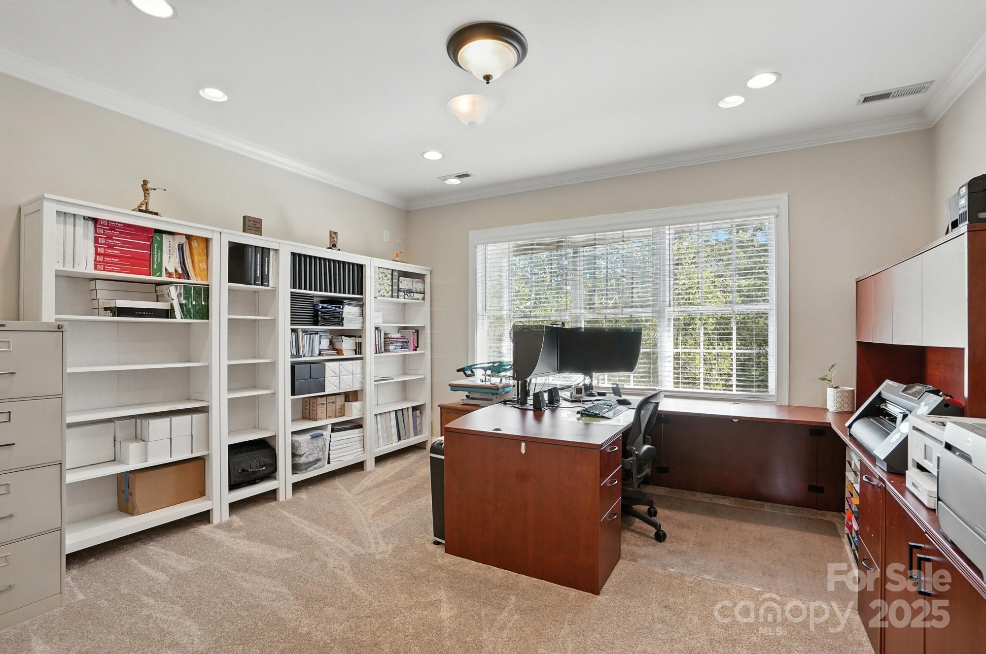 1651 Scotch Pine Lane Tega Cay, SC 29708 - Photo 34 of 48 a view of a workspace with furniture and a bookshelf