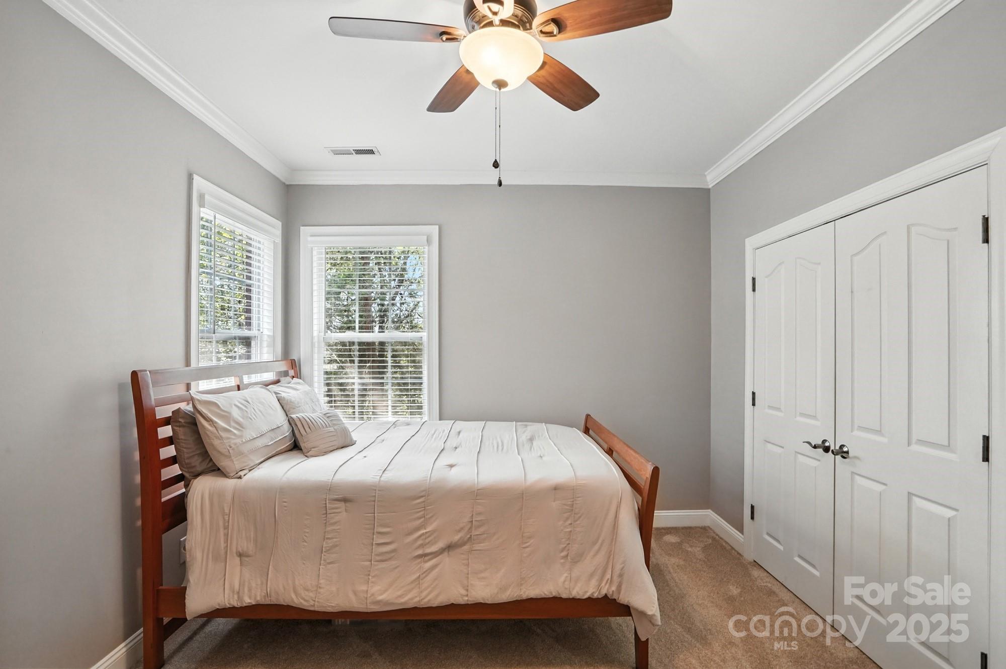 1651 Scotch Pine Lane Tega Cay, SC 29708 - Photo 37 of 48 a bedroom with a bed and a chandelier