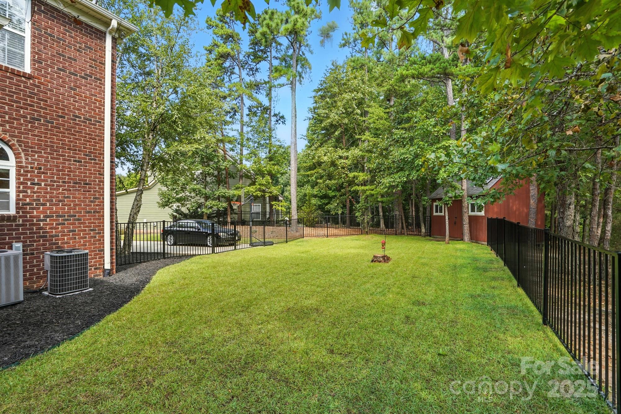 1651 Scotch Pine Lane Tega Cay, SC 29708 - Photo 38 of 48 a view of a backyard with large trees