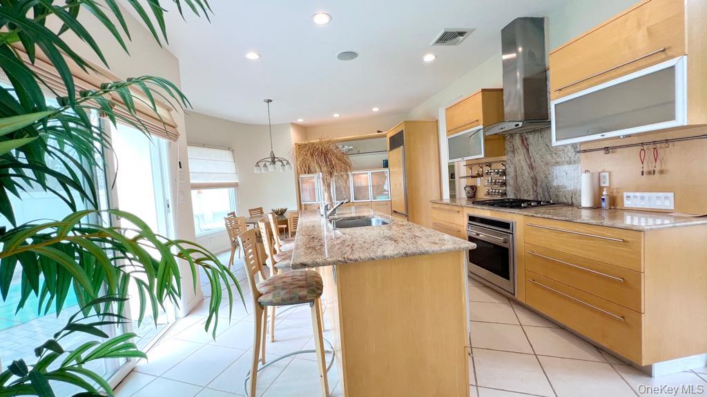 54 Matlock Street Long Beach, NY 11561 - Photo 9 of 22 a kitchen with granite countertop a sink and a stove top oven