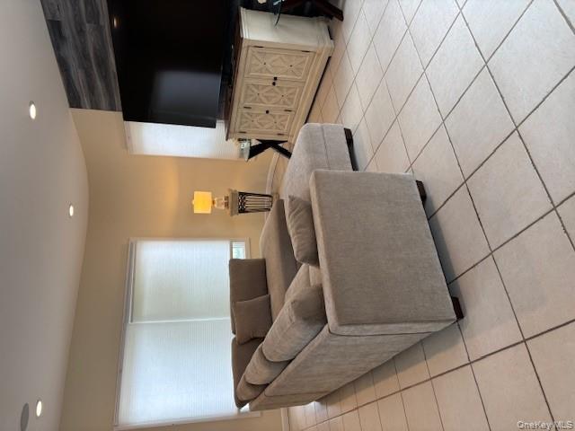 54 Matlock Street Long Beach, NY 11561 - Photo 13 of 22 a living room with couches and a flat screen tv