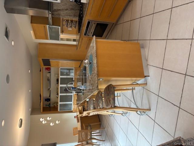 54 Matlock Street Long Beach, NY 11561 - Photo 15 of 22 a kitchen with stainless steel appliances granite countertop a table and chairs in it