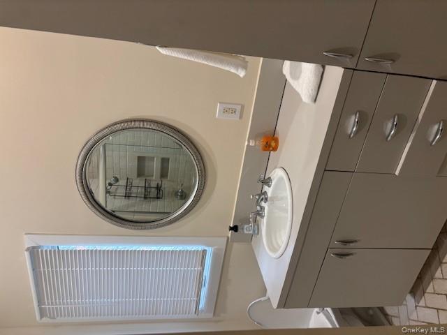 54 Matlock Street Long Beach, NY 11561 - Photo 19 of 22 a bathroom with a sink and a mirror