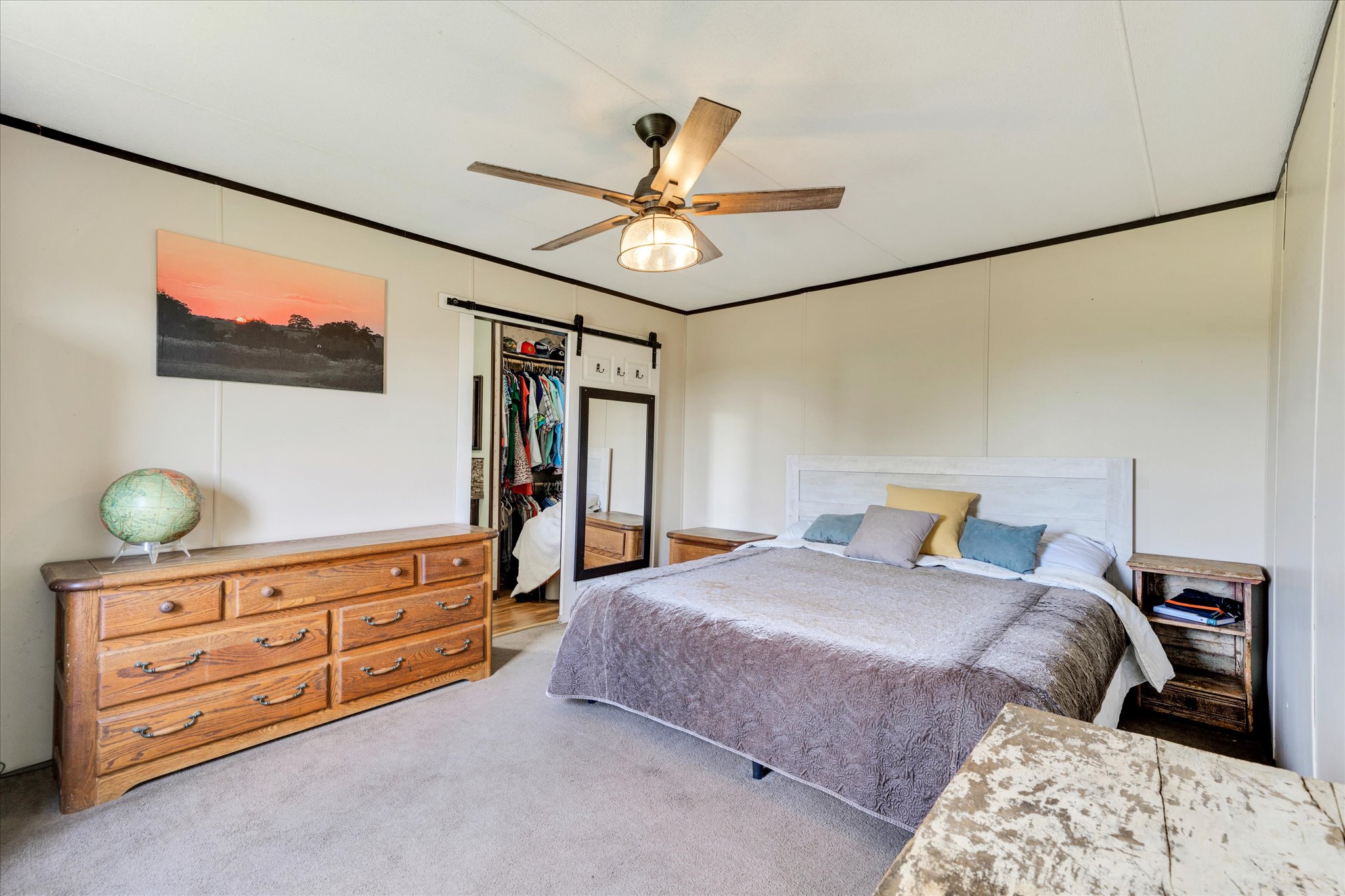1500 Wattsville Road Luling, TX 78648 - Photo 27 of 38 A well-lit primary bedroom features a ceiling fan, plush carpeting, and convenient closet access.