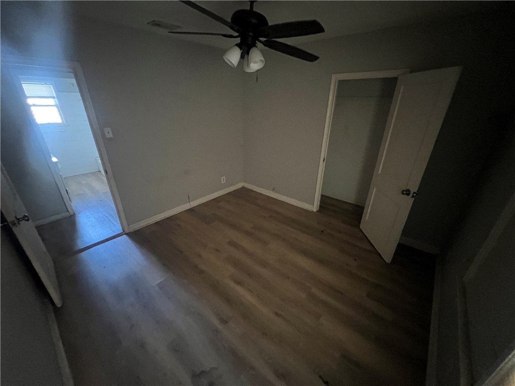 4031 West Vanderbilt Drive Corpus Christi, TX 78415 - Photo 6 of 9 wooden floor in an empty room with a window