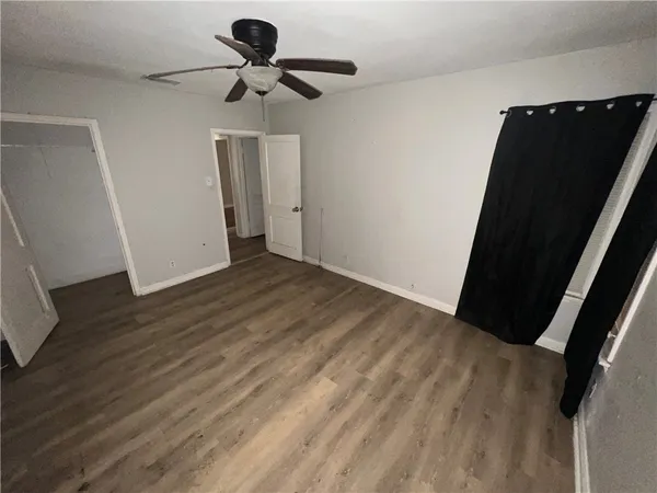 a view of room with wooden floor and carpet
