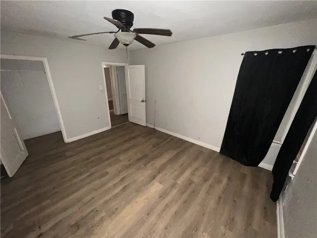 a view of room with wooden floor and carpet