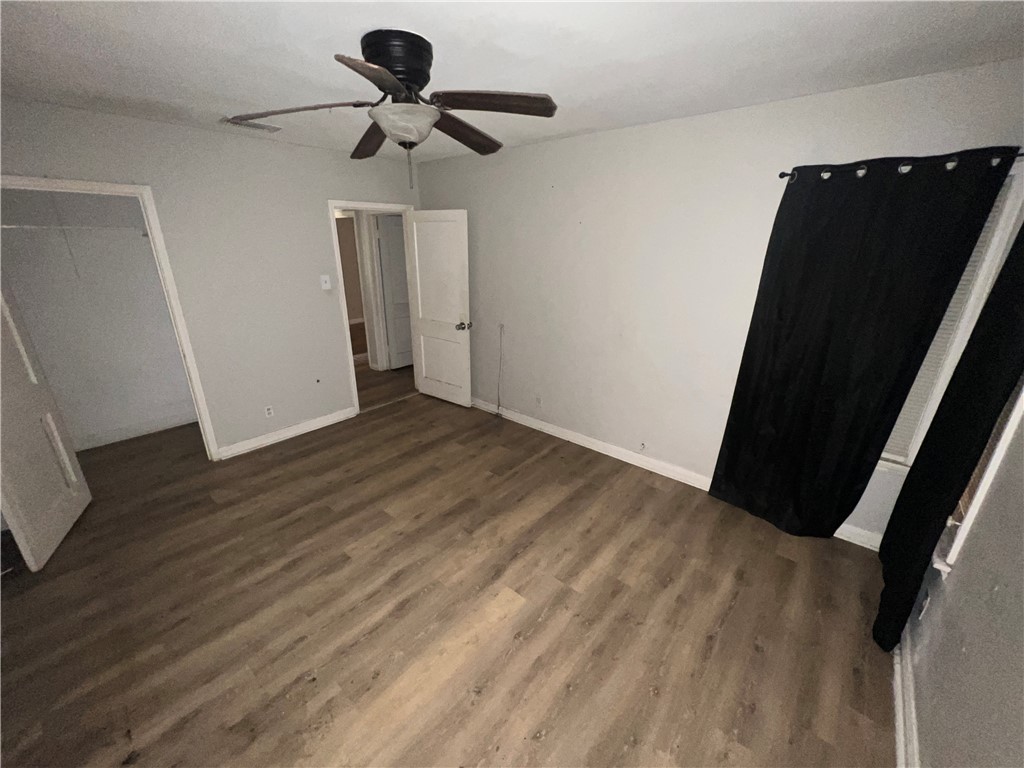 4031 West Vanderbilt Drive Corpus Christi, TX 78415 - Photo 8 of 9 a view of room with wooden floor and carpet