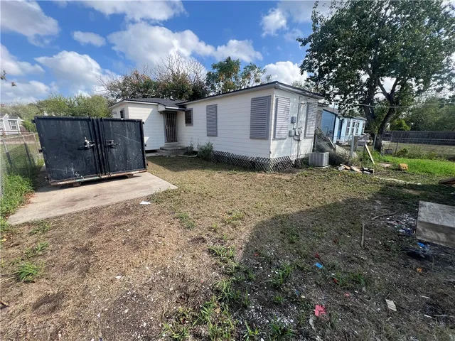 a view of a house with backyard and trees